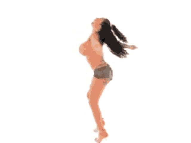 a woman in shorts is dancing with her arms outstretched .