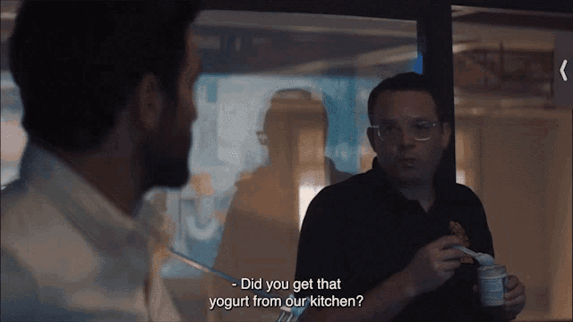 a man talking to another man about yogurt