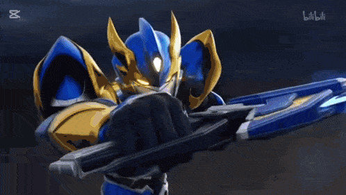 a blue and gold robot is holding a blue sword in his hand .