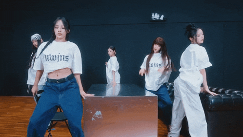 a woman wearing a white shirt that says niwjins