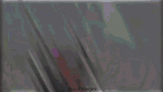 a blurry picture of a person standing in front of a purple and blue background
