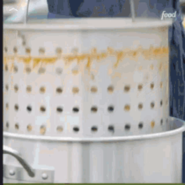 a white pot with holes in it and the word food on it