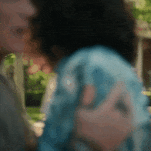 a blurry picture of a man and a woman talking