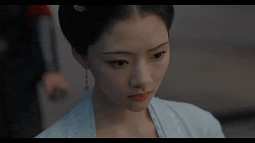 a close up of a woman 's face with a very serious look on her face