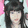 a blurry picture of a woman 's face with long black hair and cat ears .
