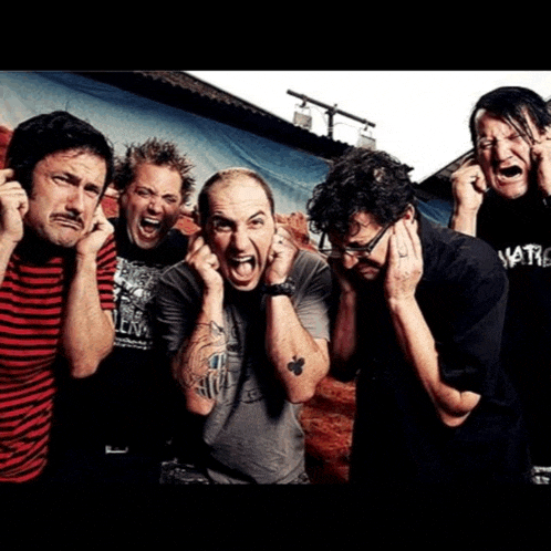 a group of men are covering their ears with their hands and one has a shirt that says nation