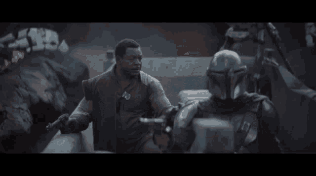 two men are standing next to each other and one is pointing