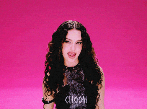 a woman sticking her tongue out wearing a choom shirt