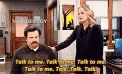 a man and a woman are talking to each other .