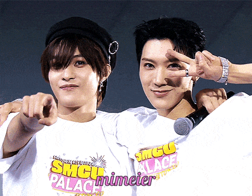 two men wearing smgu palace t-shirts pointing at the camera