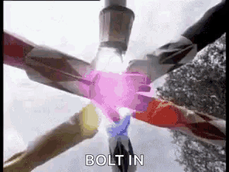 a group of power rangers are standing next to each other with their arms crossed .