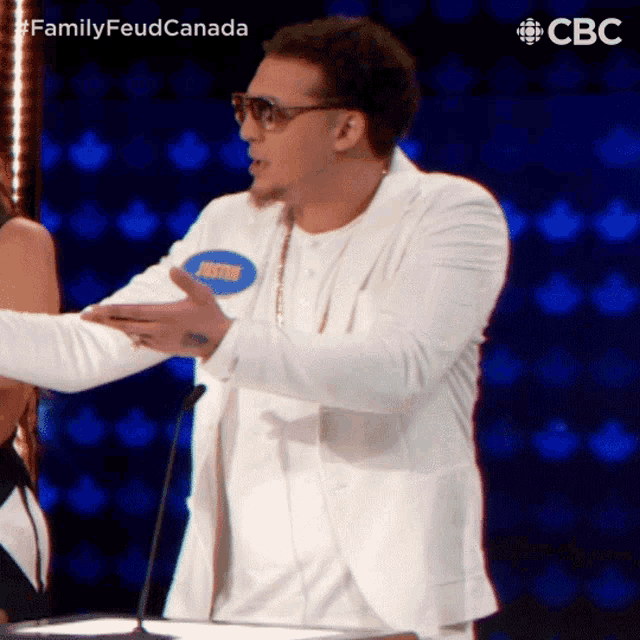 a man in a white jacket has a name tag that says justin on it