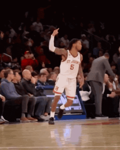 a basketball player wearing a jersey that says st. john 's on it