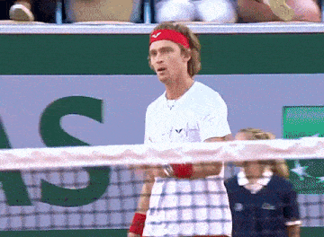 a man wearing a red headband and a white shirt with the letter s on the back