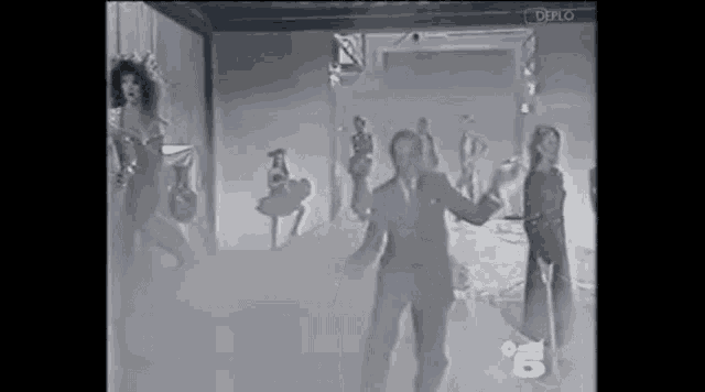 a group of people are dancing in a room with smoke coming out of the door .