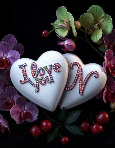 two white hearts that say i love you with flowers in the background