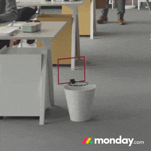 a monday.com ad shows a white trash can in an office