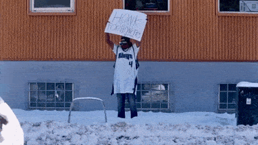a man holding a sign that reads honk for homeless