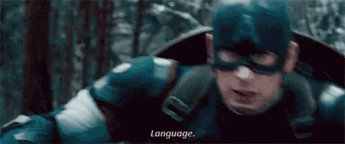 a close up of a man in a superhero costume with the words `` language '' written on the bottom .