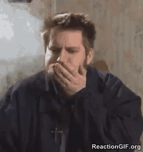 a man with a beard is covering his mouth with his hand while smoking a cigarette .