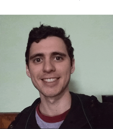 a man in a black jacket and a red sweater smiles for the camera