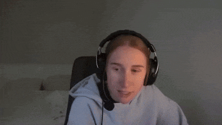 a woman wearing headphones and a microphone is sitting in front of a computer .