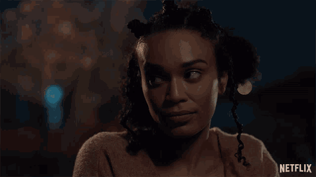 a close up of a woman 's face with the netflix logo in the corner
