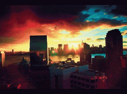 a sunset over a city with a lot of tall buildings