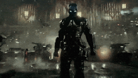 a man in a superhero suit is standing in the rain .