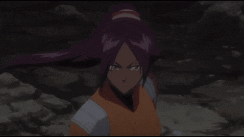 a girl with purple hair and a ponytail looks at the camera