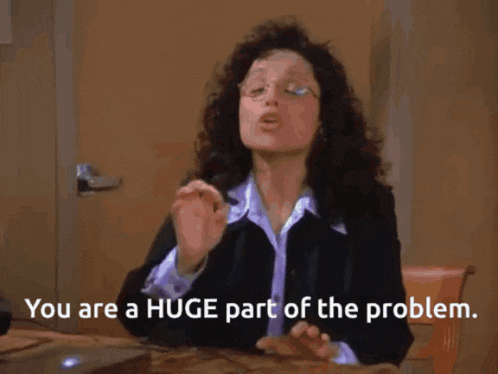a woman sitting at a desk with the words " you are a huge part of the problem " below her