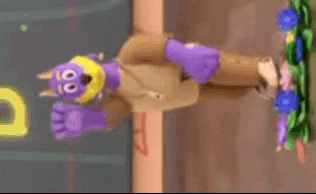 a stuffed animal with purple ears is hanging upside down on a wall .
