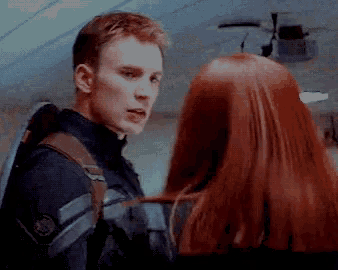 a man and woman are looking at each other