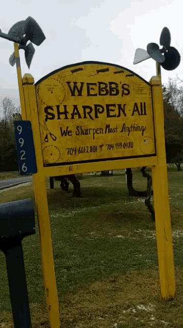 a yellow sign that says webb 's sharpen-all on it