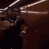 a blurry picture of a person dancing in a room with lights behind them .