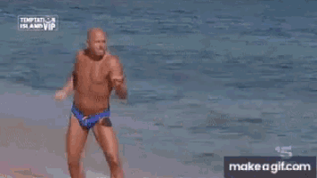 a man and woman are dancing on a beach .