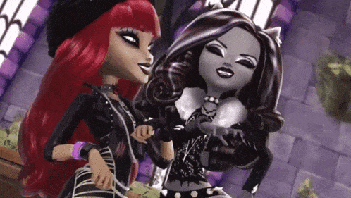 two monster high dolls posing for a picture