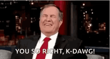a man in a suit and tie is laughing and says you so right k-dawg