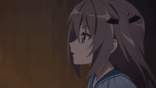 a close up of a girl 's face with a blue shirt on