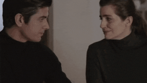 a man and a woman are looking into each other 's eyes