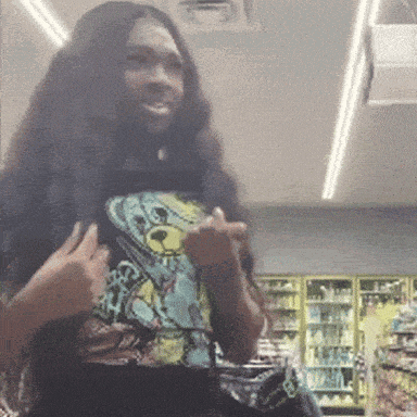 a woman with long hair is wearing a teddy bear shirt and giving the middle finger