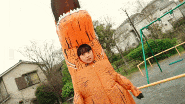 a woman is wearing an inflatable dinosaur costume in a park