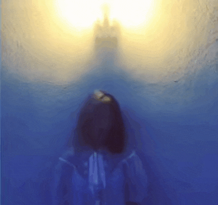 a blurred image of a person in a blue jacket