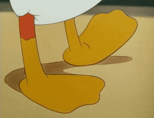 a close up of a cartoon character 's feet on a sandy surface