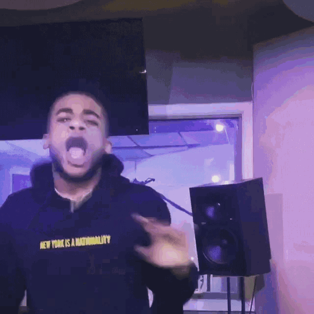 a man wearing a black sweatshirt that says new york is nationality