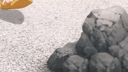 a cartoon character is standing next to a pile of rocks .
