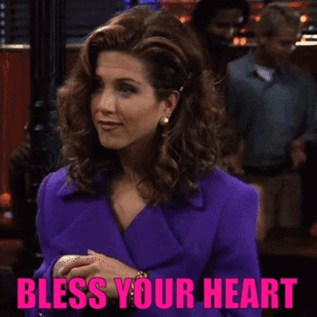 a woman in a purple jacket is smiling with the words bless your heart above her
