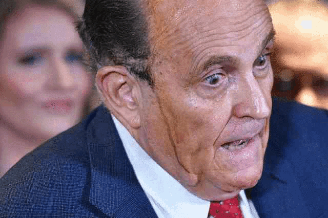 a close up of a man in a suit and tie