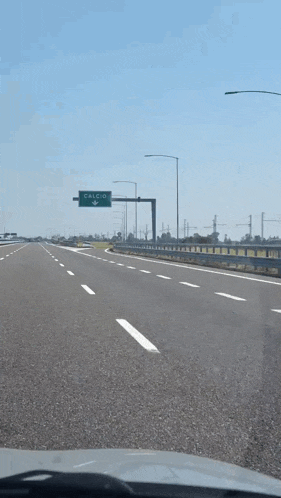 a green sign on the side of a highway that says calcutta