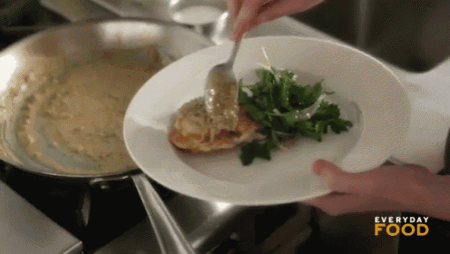 a person is putting food on a plate that says everyday food on the bottom